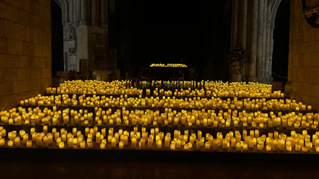 Rows of candles on the steps of Southwark Cathedral before Candlelight: Disney Love Songs, with the quartet chairs waiting at the far end